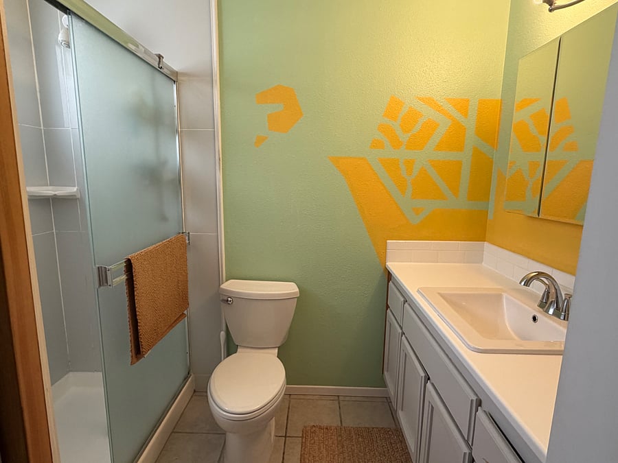 Ensuite private bathroom with step-through shower, bidet, and plenty of storage space.