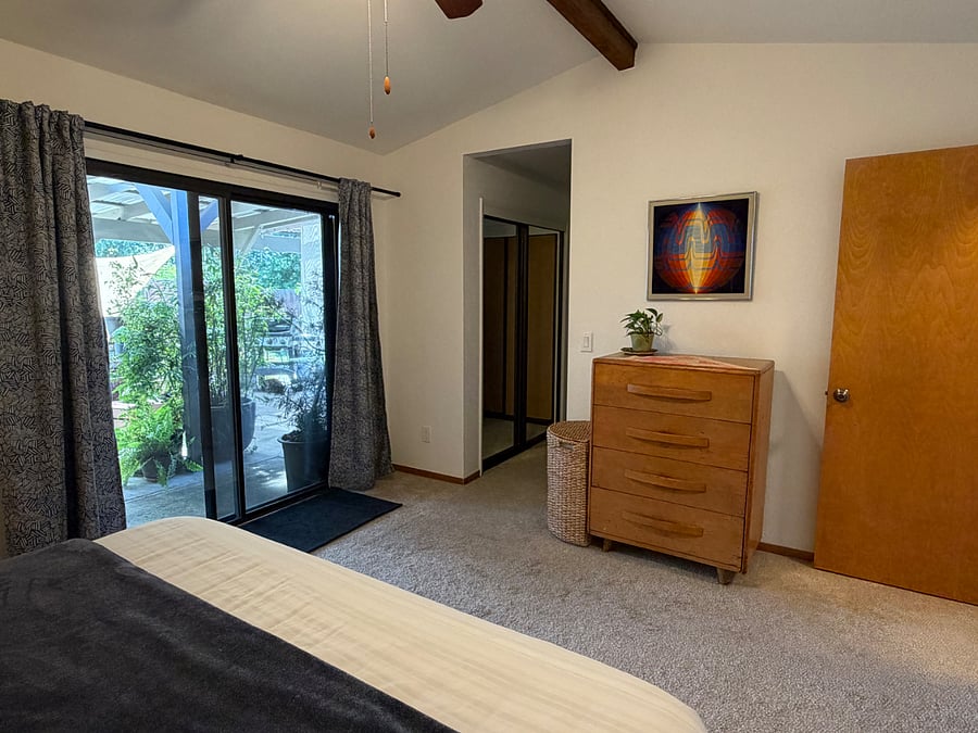 Blackout curtains for peaceful sleep. Mirrored closets leading to the ensuite bathroom.