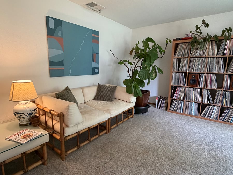The second living room we call "the front room." It is sunny and spacious with a view of the front yard. Features a piano, orchids, and records.