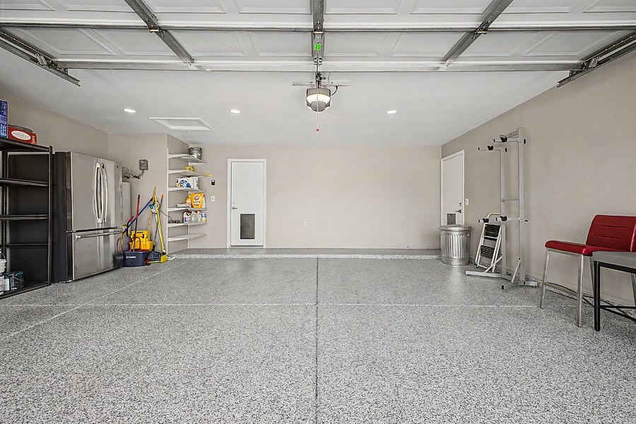 2 car garage with extra fridge/freezer and storage shelves