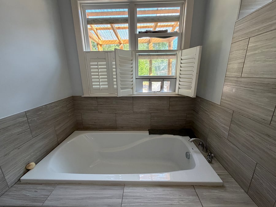 Primary bath bathtub (and cat window to the catio)