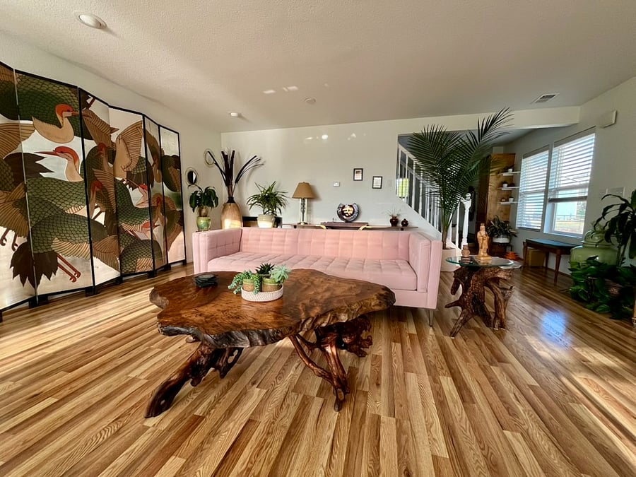 A view into the living room from the back of the house. Chinese screens, live edge redwood coffee table, piano (not visible here), and loads of comfy seating!