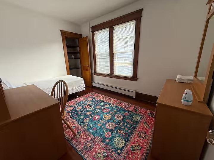 Dresser bed, computer desk, closet, windows.