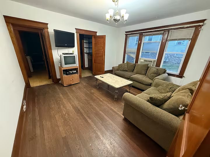 Living room with TV couch, loveseat, and coffee table.