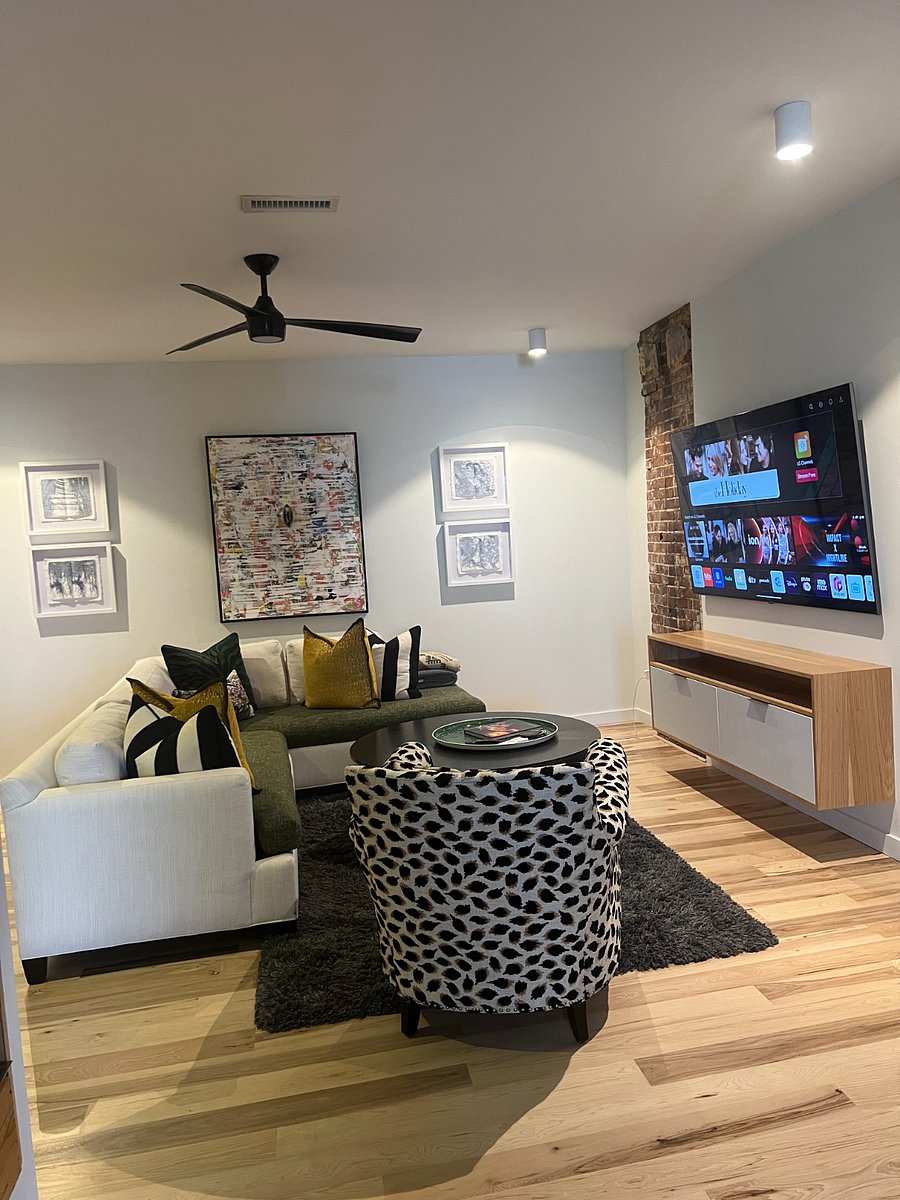 Living room with comfy seating and a smart TV.