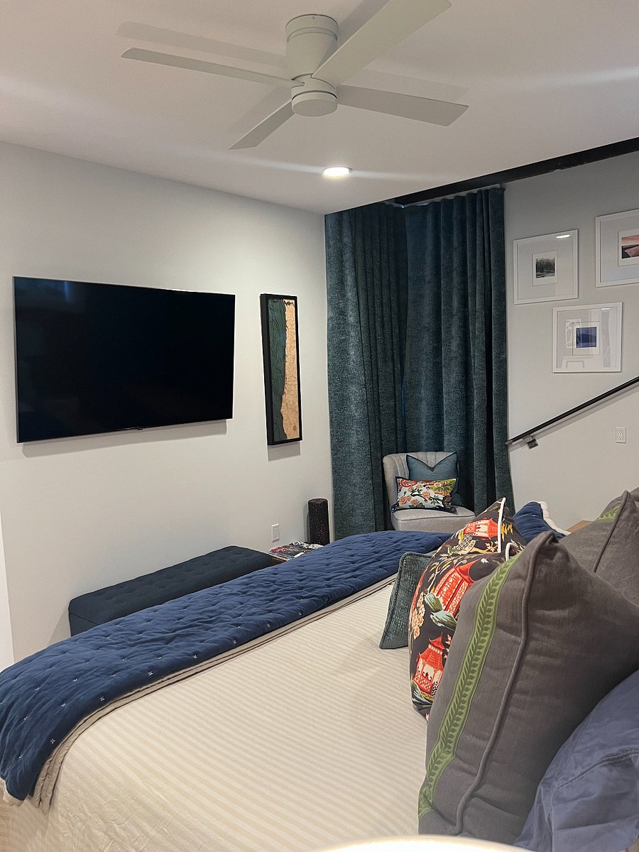 Master bedroom TV and stairs to indoor/outdoor room. 