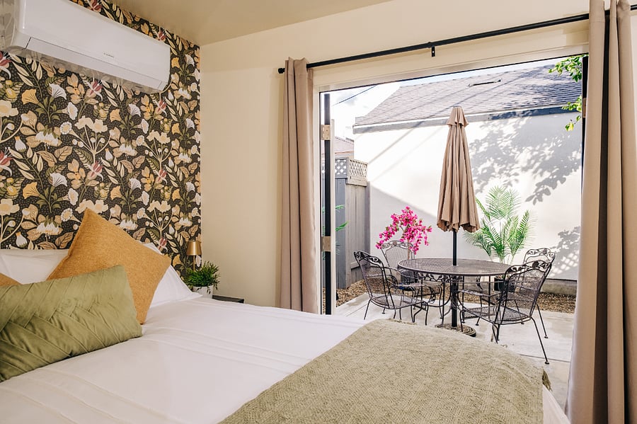 French door open to courtyard off primary bedroom