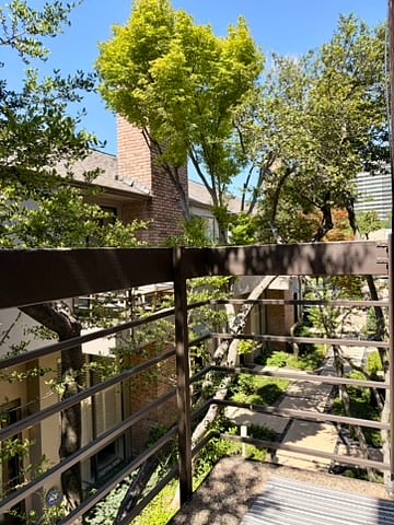 This is the view of the balcony off the primary bedroom and looking down the entry to the building.
