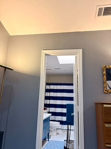 The primary bedroom's door entering into the bathroom.