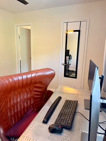 The second bedroom is setup as an office and contains a dual monitor, modern desk and chair, and a Peloton, making the home convenient for a work from home setup and no need for a gym membership.