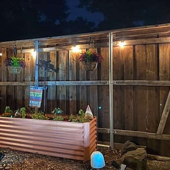 The backyard has remote controlled lights making the backyard an oasis on summer nights.