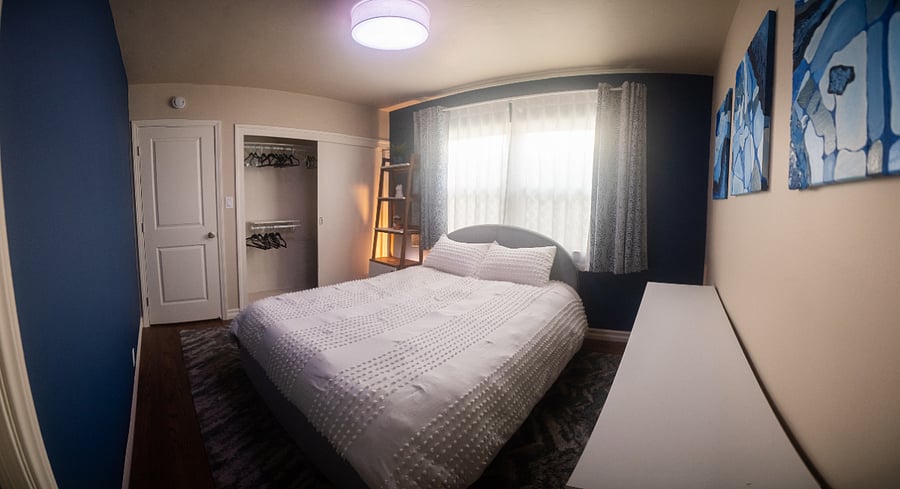 Main bedroom comes with dresser, shelf/storage organizer, and closet. The windows have sheer and blackout curtains on French style (wraparound) curtain rods.