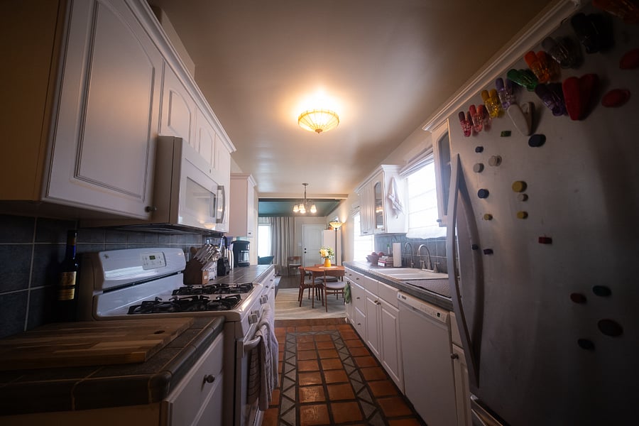 Kitchen has original tile but updated appliances and a giant fridge!