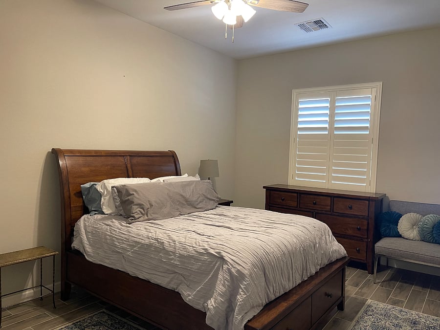 Bedroom #1 w/ Queen Bed, Dresser, Nightstand, Closets, and Two Chairs.