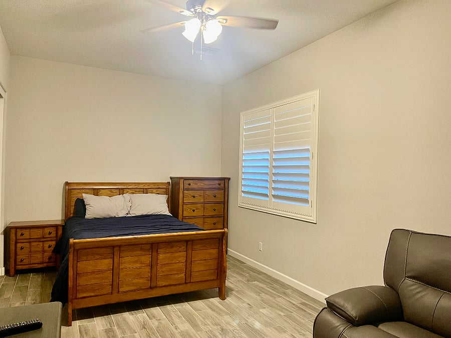 Bedroom #2 w/ Queen Bed, Dresser, Nightstand, Closets, Loveseat, and TV.