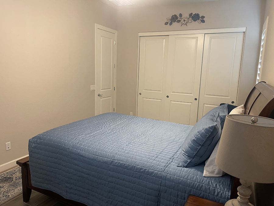Bedroom #1 w/Queen Bed, Dresser, Nightstand, Closets, and Two Chairs.