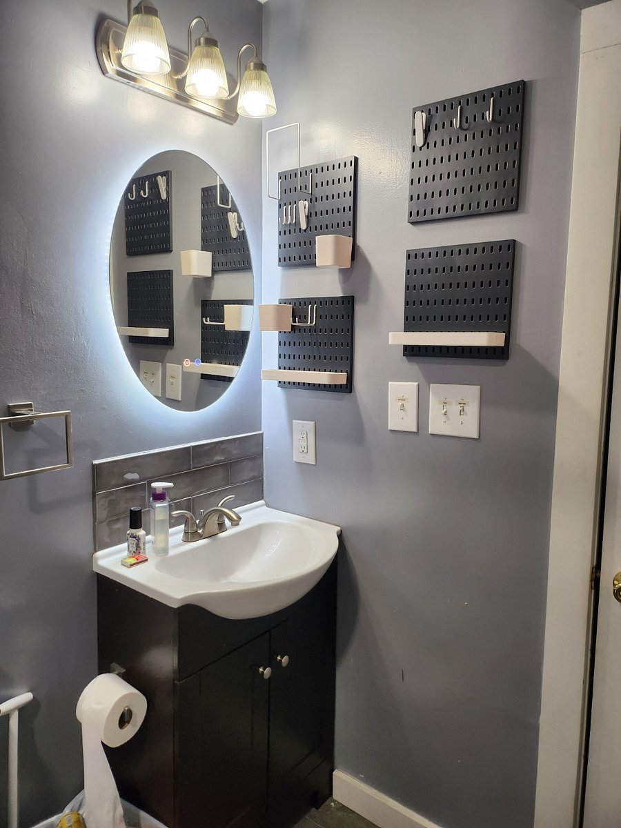 Backlit mirror in tub room.