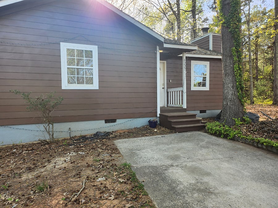 Small front yard with private driveway. This is a duplex; everything in the photo is part of your half. To the left (off-camera) is my neighbor's half.