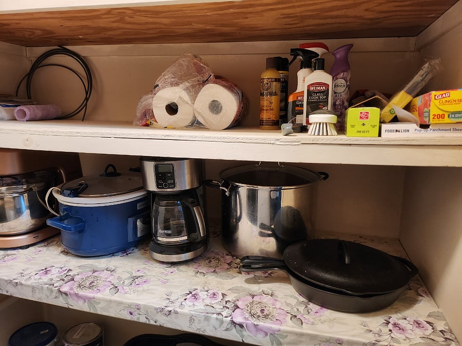 Appliances and supplies in laundry room with plenty of storage space to spare.
