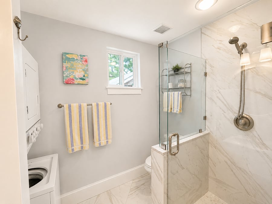 Renovated bathroom with washer and dryer.
