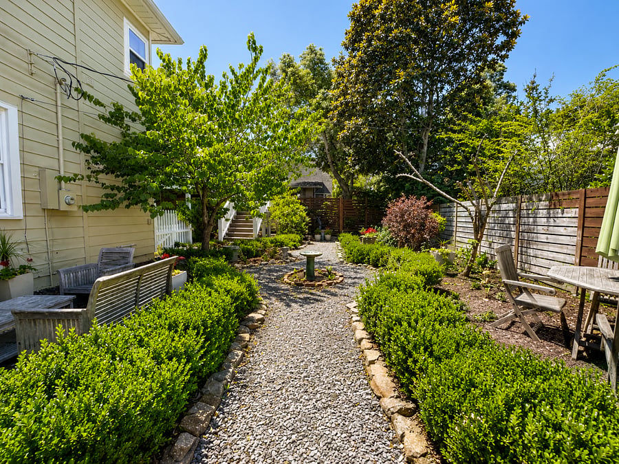 View of garden walk and outdoor furniture.