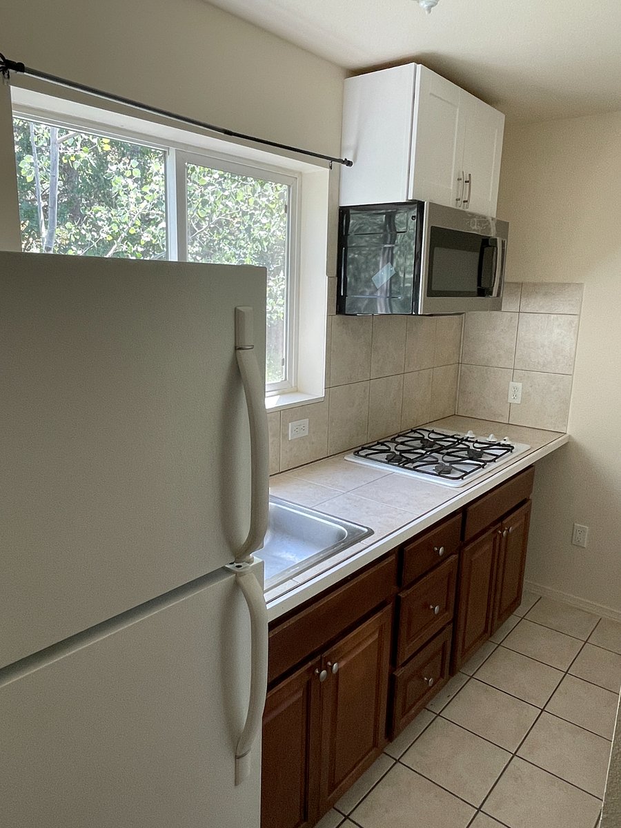 Kitchen with full size fridge, cooktop (no oven) and new microwave