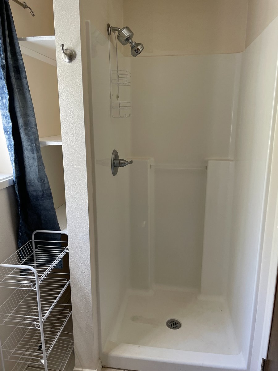 Stall shower and storage shelves