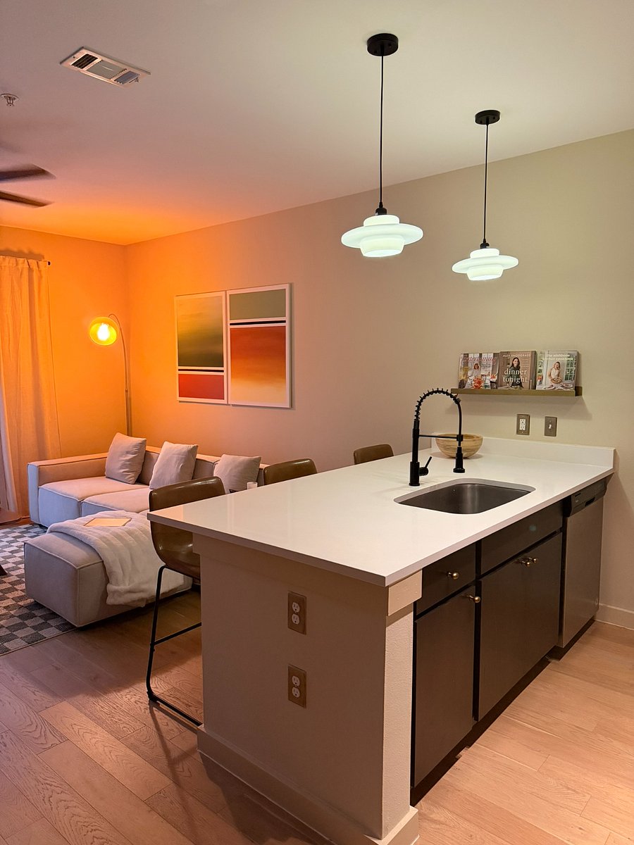Open kitchen and living space with 3 bar stools to easily entertain guests. 