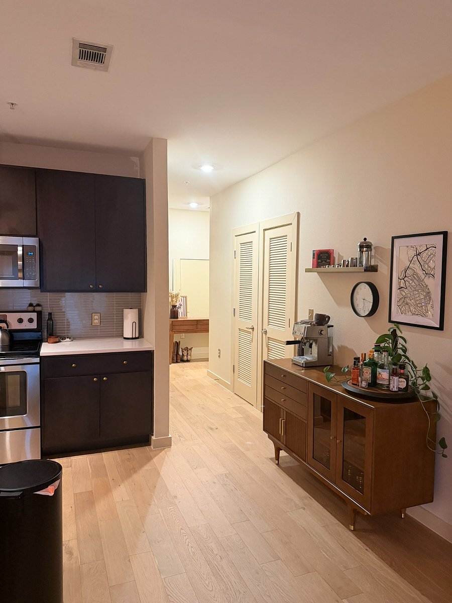 Open hallway from entryway into kitchen and bar area