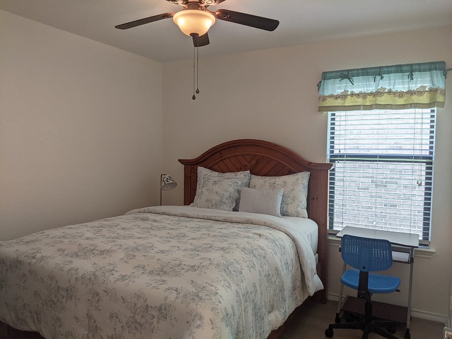 Bedroom features a queen bed with new linens, a work space full of natural light from the big window.