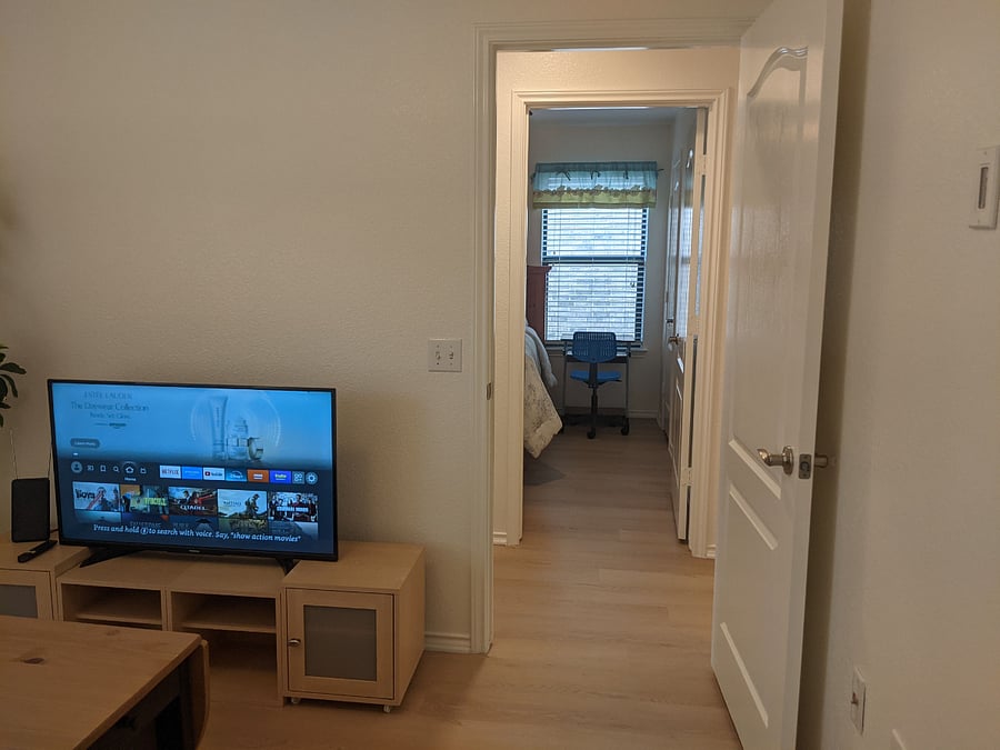 View from the living room to the hallway and bedroom.