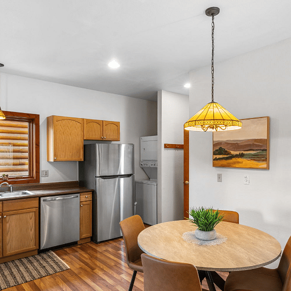 Stackable washer dryer next to the refrigerator