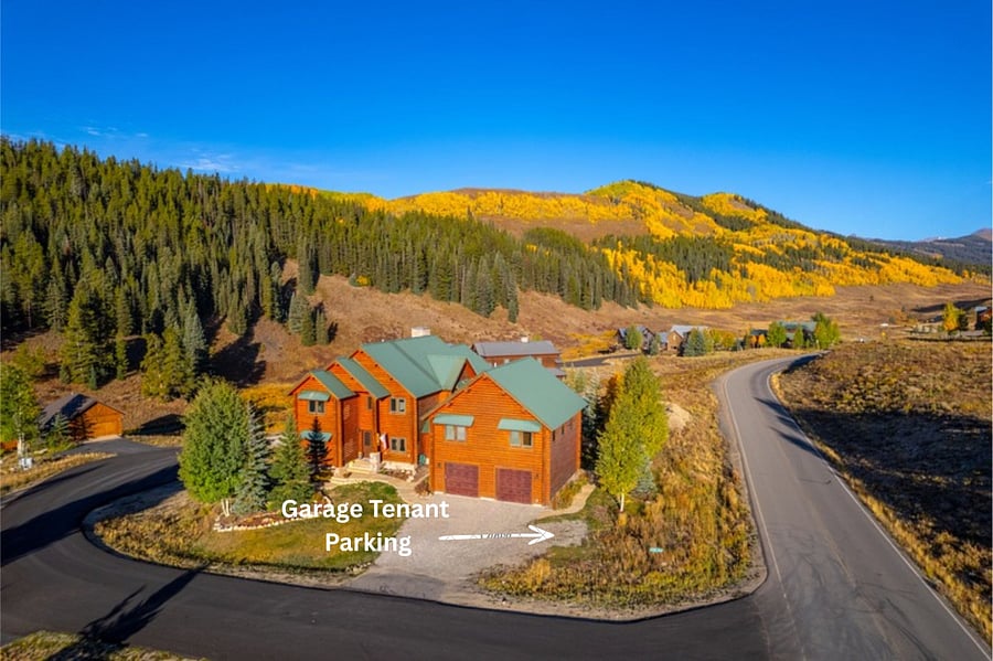 Designated garage tenant parking to the right of the driveway