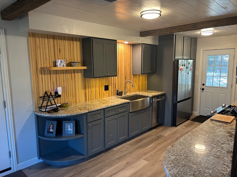 Kitchen with dishwasher and refrigerator with ice maker and filtered water dispenser.