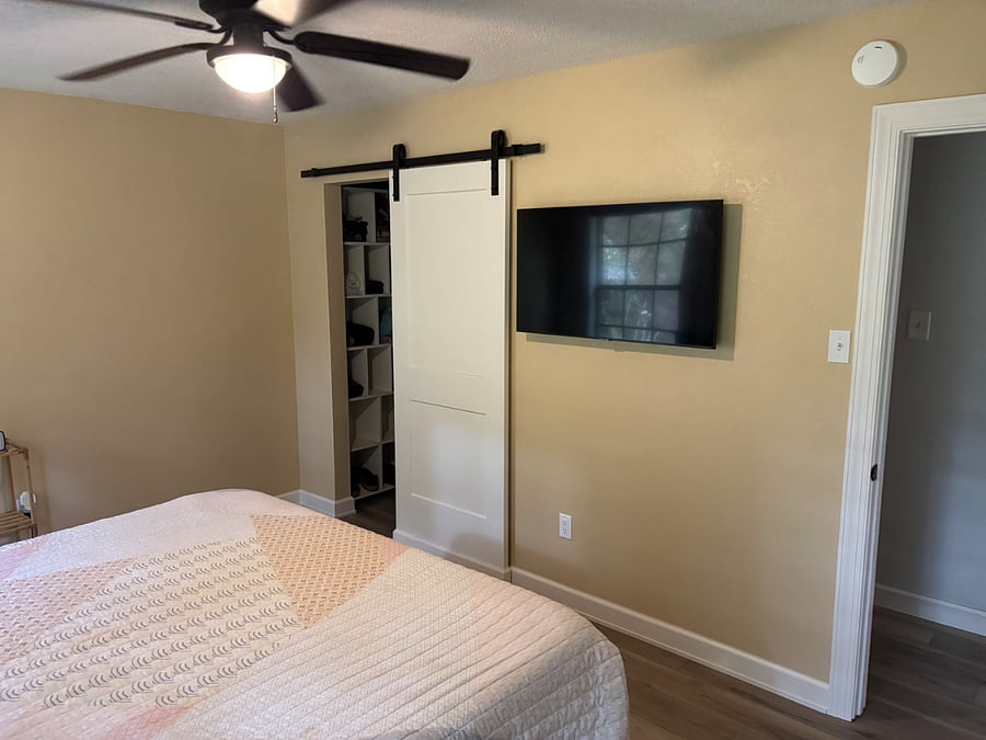 Master bedroom with closet and smart tv.