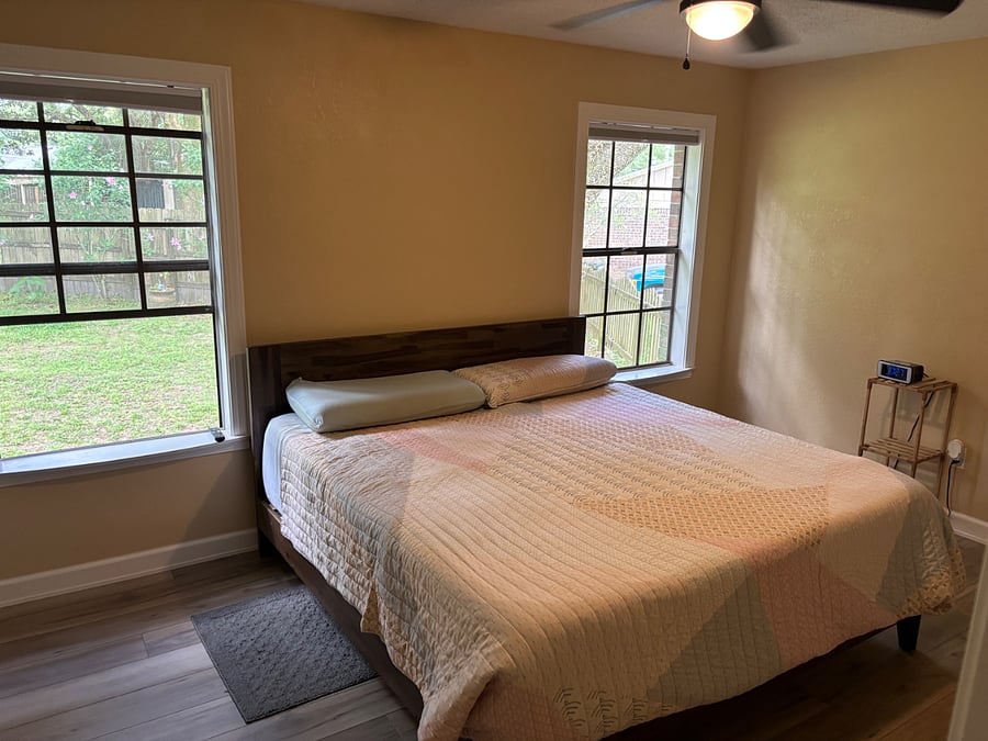 Master bedroom with king size memory foam bed and ceiling fan.