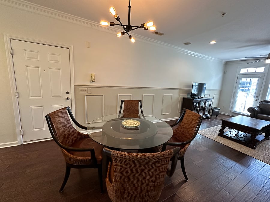 Glass dining room table with 4 comfortable leather chairs.