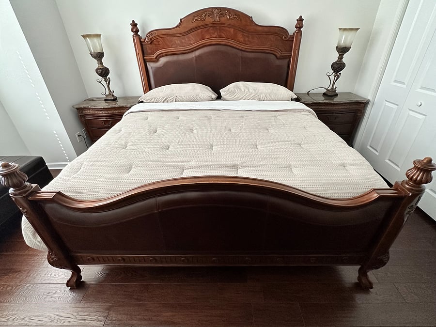 King bed in primary bedroom with two genuine marble top nightstands. .