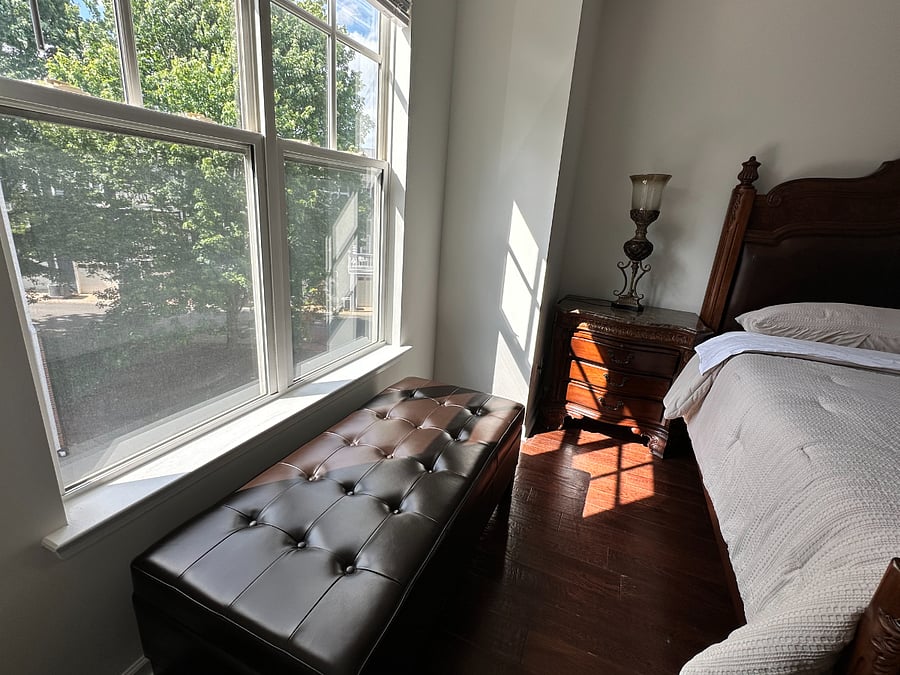 Leather ottoman that opens up and stores blankets and pillows (main bedroom) with large windows to let in plenty of natural light.
