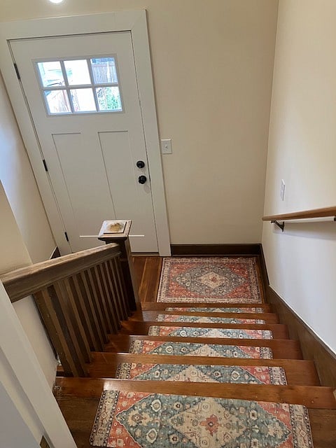Interior entry stairs from private entrance in backyard
