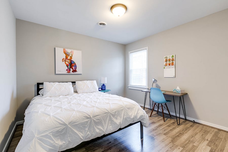 Bedroom one with queen bed and work space
