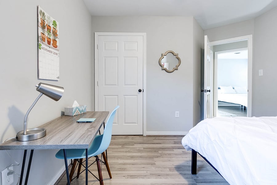 Bedroom one with queen bed and workspace