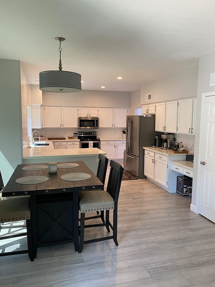 View of kitchen and breakfast table from family room.