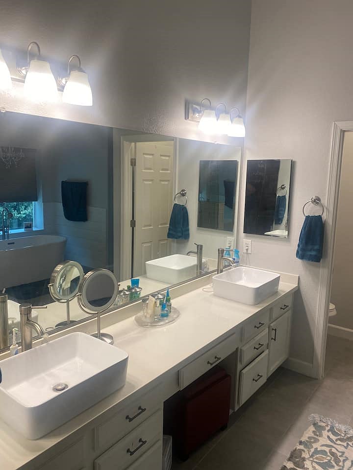 Master bathroom double sinks. Private toilet located next to double sinks.