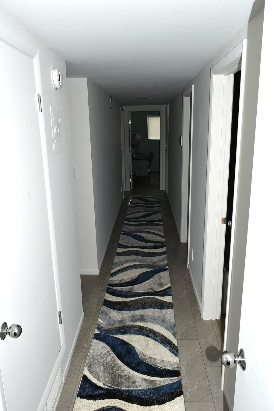 Long hall leading to all bedrooms and two bathrooms