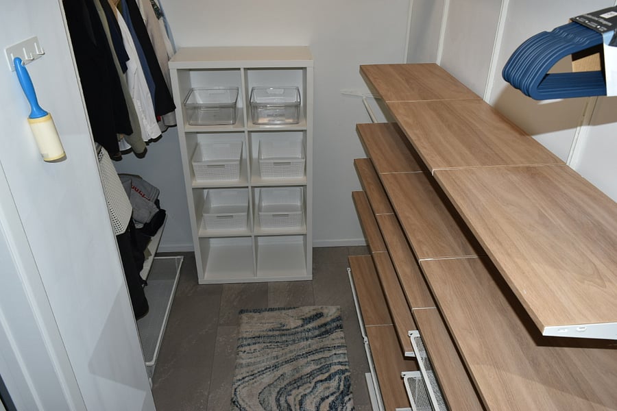 Master walk in closet with racks, shelves, and drawers, shoe cabinet. Overhead shelving for storage. Bright lights. Full length mirror