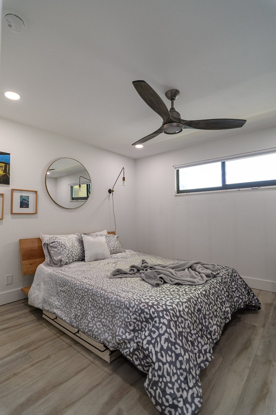 Guest suite with queen bed, reading nook, and private access to guest bath.