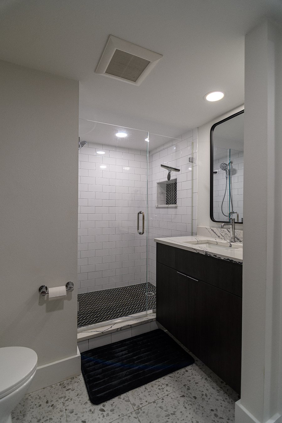 Walk in shower and luxury quartz surfaces.