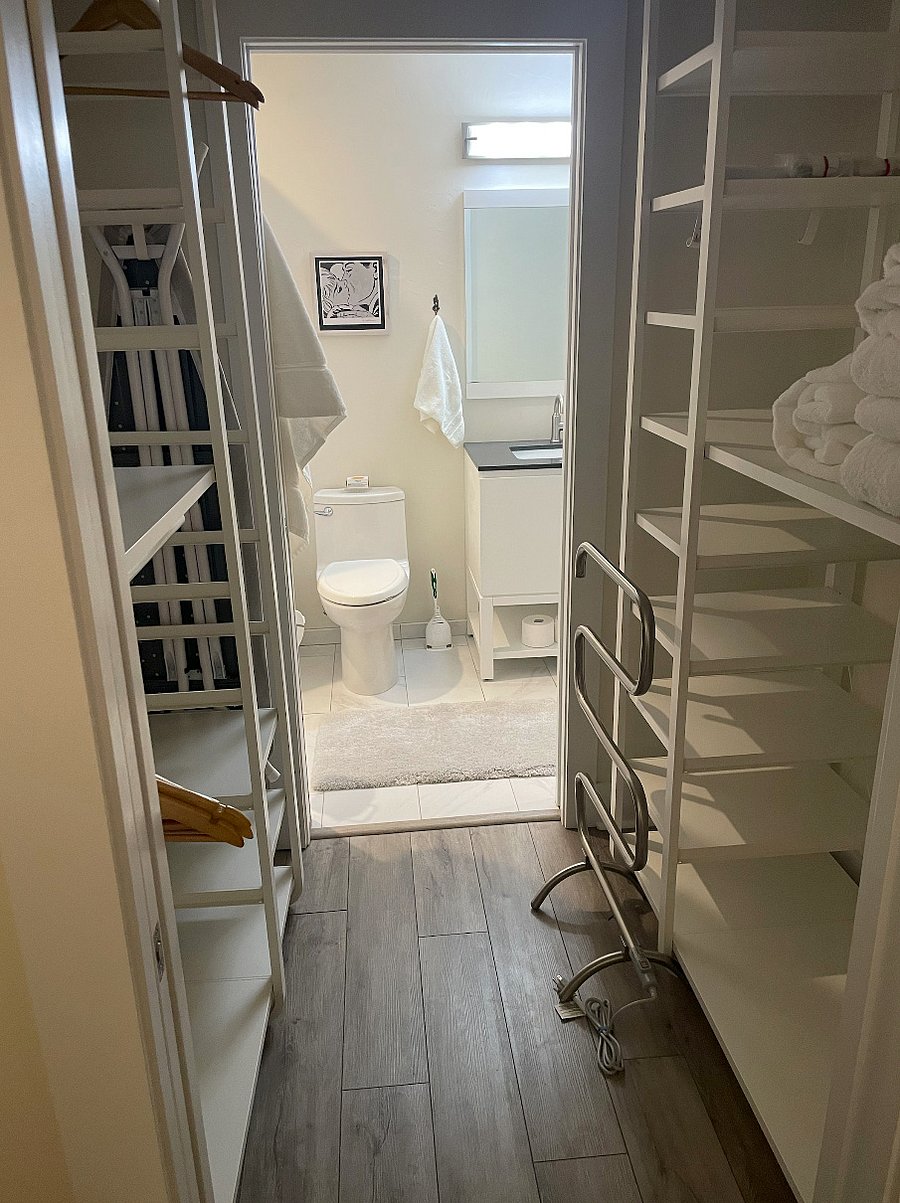Walk-through closet with generous Ikea wardrobe units. Convenient pocket doors are featured throughout living area.