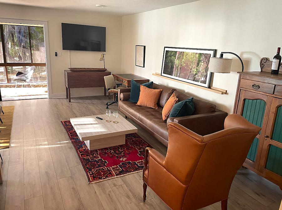 Open plan layout, including TV, work area & sunroom